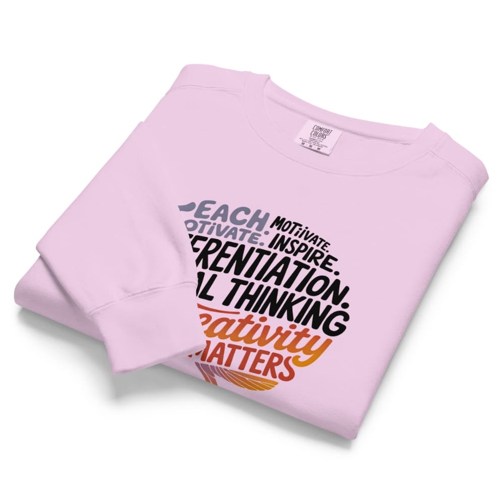 Folded pink sweatshirt with text on a white background