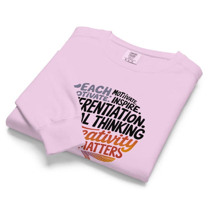 Folded pink sweatshirt with text on a white background