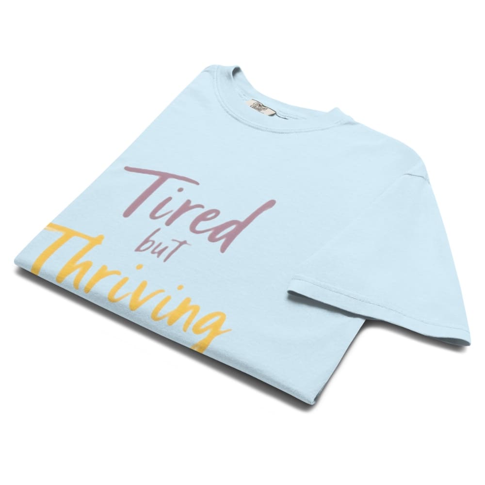 Garment-dyed relaxed fit t-shirt with motivational quote “Tired But Thriving” in modern handwritten script
