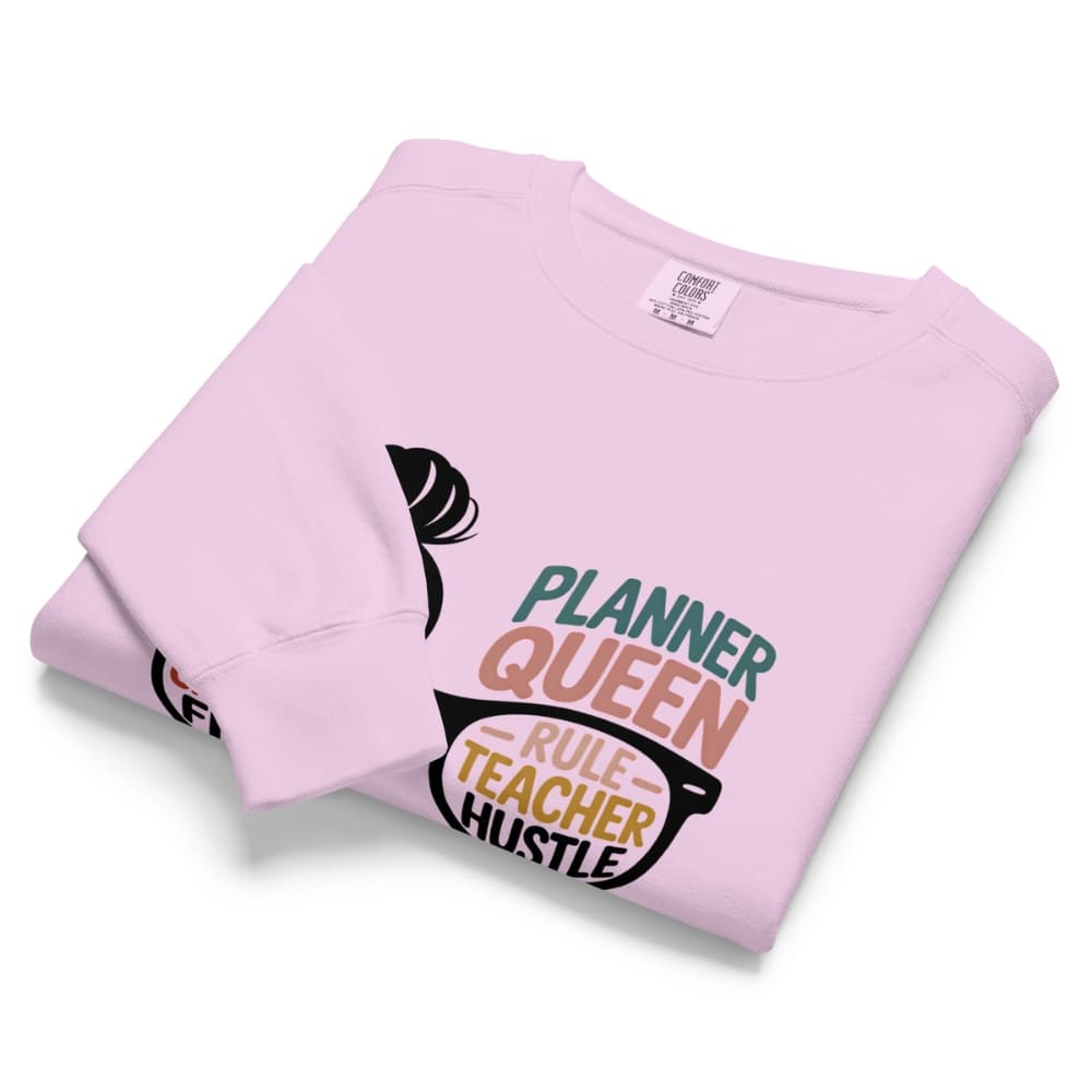 Folded pink sweatshirt with text design on a white background