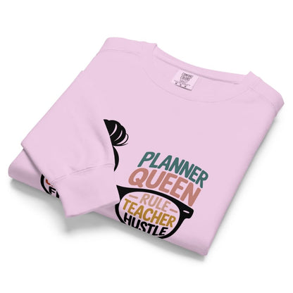 Folded pink sweatshirt with text design on a white background