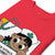 Red t-shirt with a cartoon character and medical-themed design on a white background