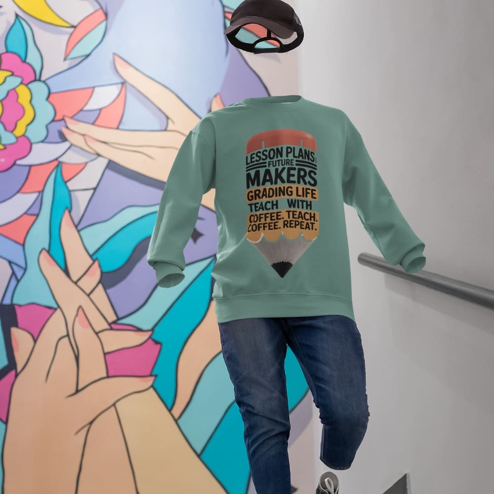 Person wearing a green sweatshirt with text in front of a colorful mural.