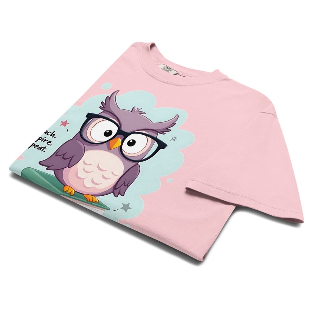 Cute purple owl with glasses sitting on stacked books, with quote "Teach. Inspire. Repeat." – printed on a teacher t-shirt