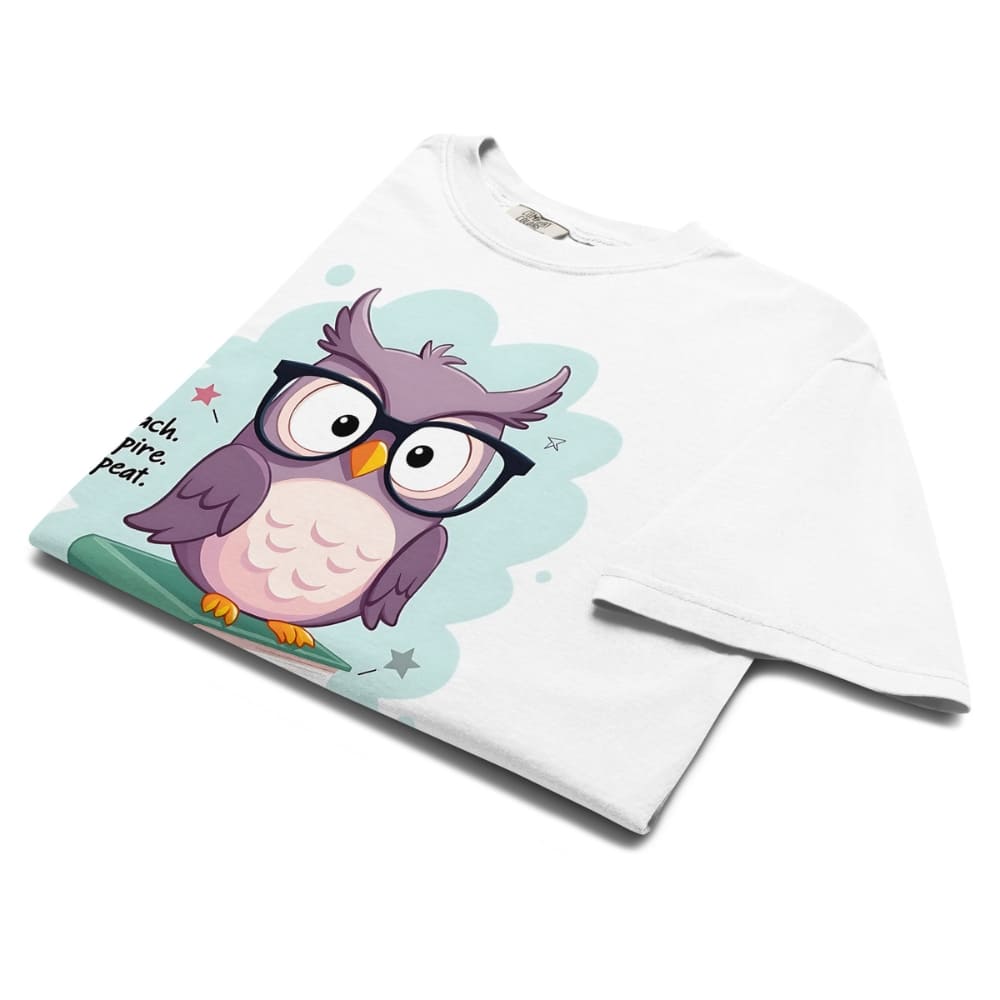 Cute purple owl with glasses sitting on stacked books, with quote "Teach. Inspire. Repeat." – printed on a teacher t-shirt