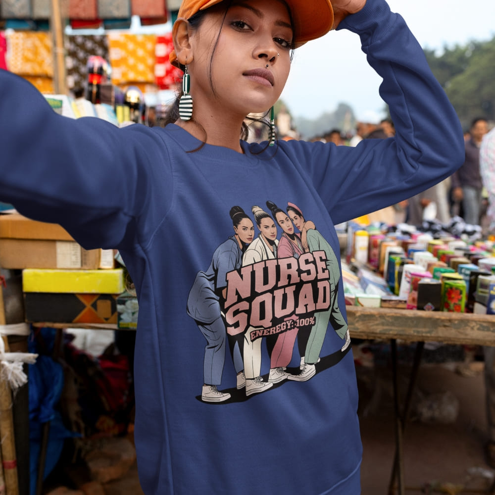 Person wearing a blue sweatshirt with 'Nurse Squad' design in an outdoor market setting