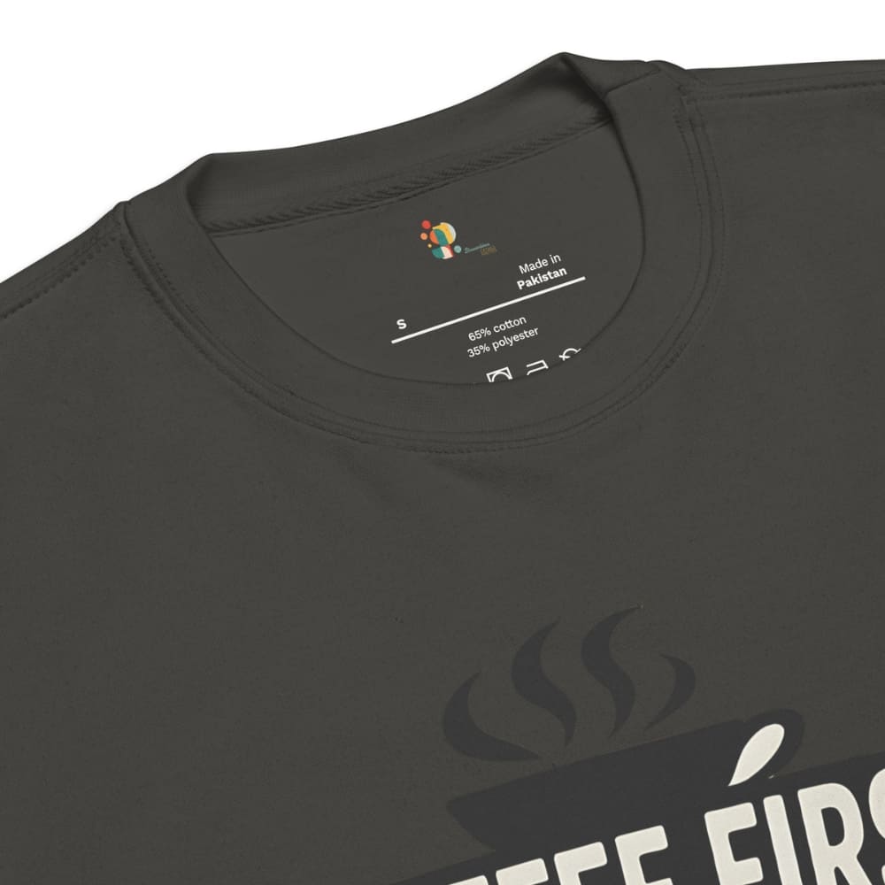 Black t-shirt with 'Coffee First' text and coffee cup graphic, showing label details.