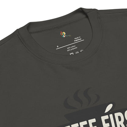 Black t-shirt with 'Coffee First' text and coffee cup graphic, showing label details.