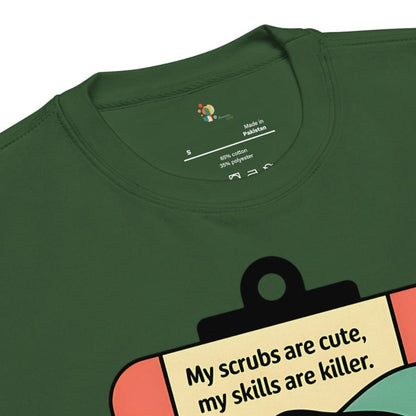 Green t-shirt with a graphic and text 'My scrubs are cute, my skills are killer.'