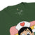 Green t-shirt with cartoon character wearing a nurse's hat on a white background