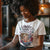 Person wearing a t-shirt with a graphic design and text in a casual setting.