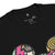 Black t-shirt with colorful graphics and text on a white background