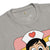 Gray t-shirt with cartoon character wearing a nurse's hat featuring a red heart on a white background.