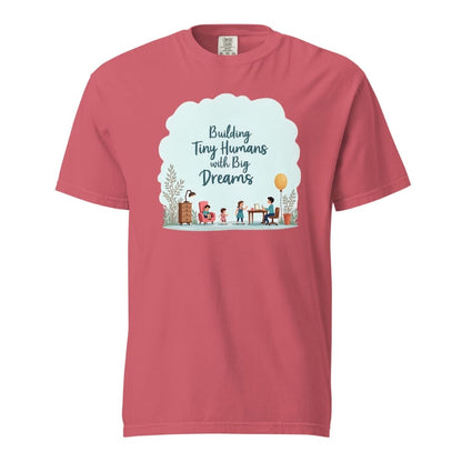 Illustrated t-shirt design with the quote "Building Tiny Humans with Big Dreams" surrounded by a family parenting scene