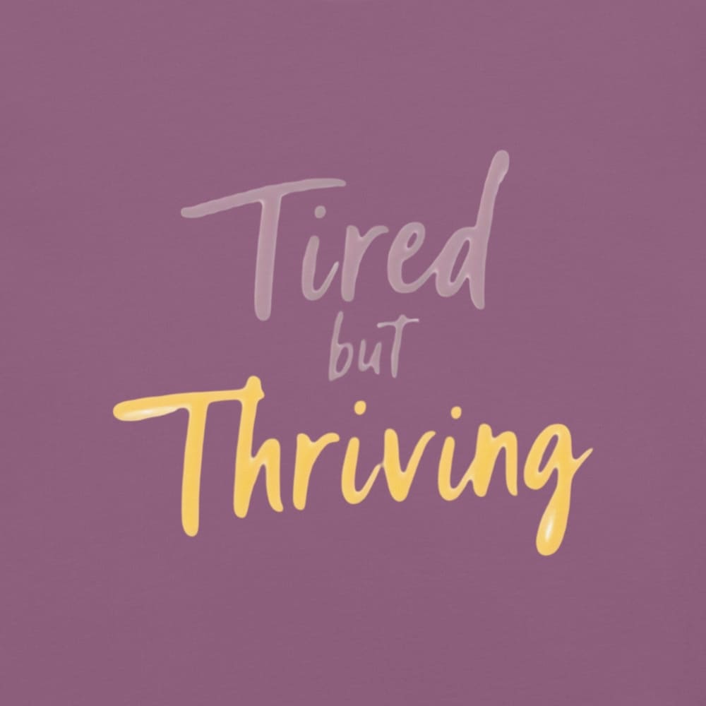 Garment-dyed relaxed fit t-shirt with motivational quote “Tired But Thriving” in modern handwritten script