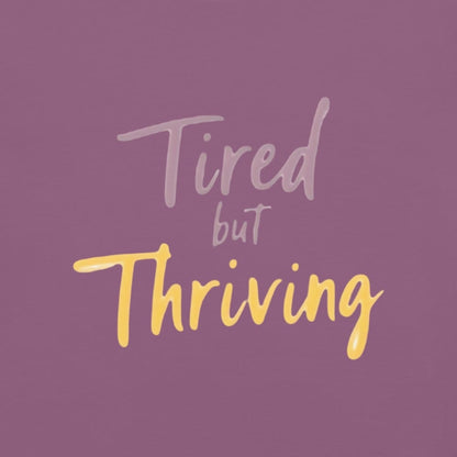 Garment-dyed relaxed fit t-shirt with motivational quote “Tired But Thriving” in modern handwritten script