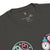 Black t-shirt with colorful graphics and brand logo on a white background