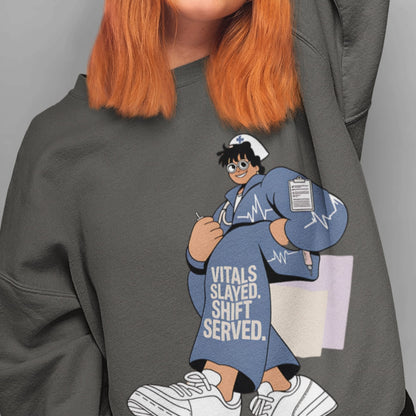 Person wearing a gray sweatshirt with a cartoon character and text 'Vitals Slaved. Shift Served.'