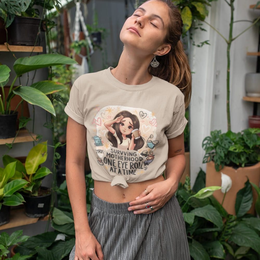 Woman wearing a graphic t-shirt in a plant-filled indoor setting