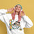 Person wearing a white sweatshirt with a cartoon character and text on a yellow background