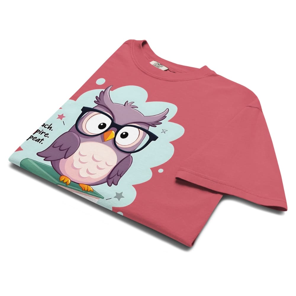 Cute purple owl with glasses sitting on stacked books, with quote "Teach. Inspire. Repeat." – printed on a teacher t-shirt