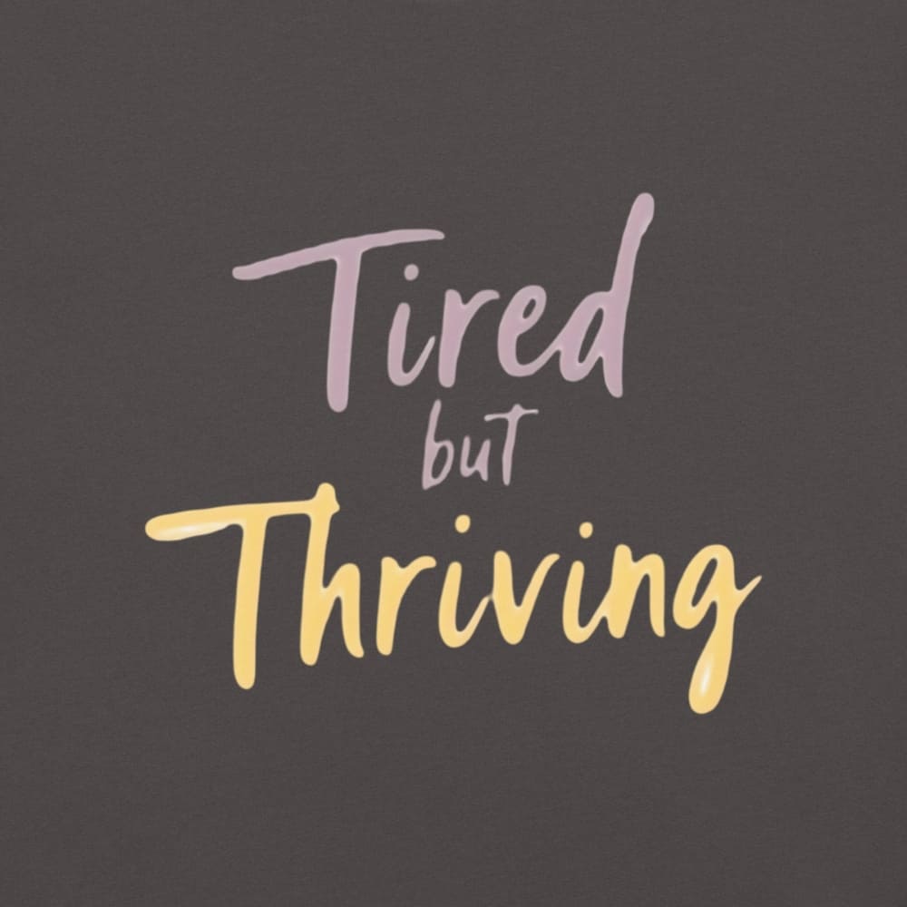 Garment-dyed relaxed fit t-shirt with motivational quote “Tired But Thriving” in modern handwritten script