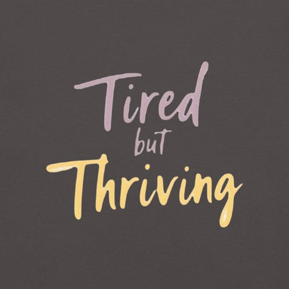 Garment-dyed relaxed fit t-shirt with motivational quote “Tired But Thriving” in modern handwritten script