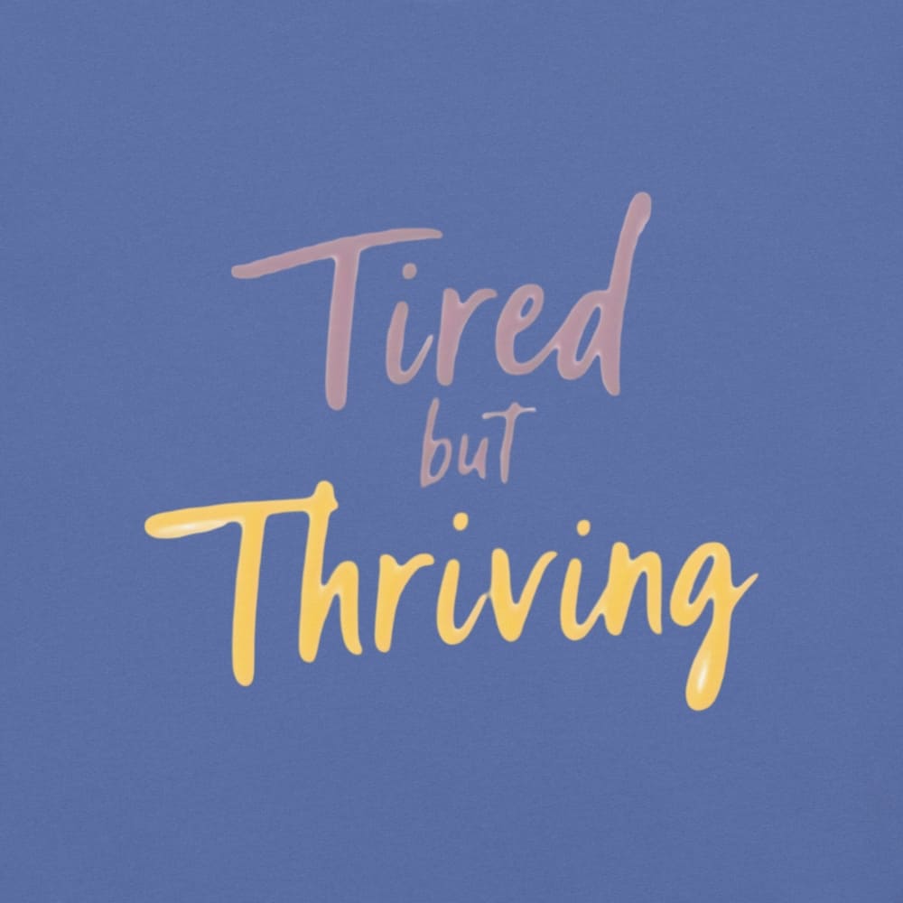 Garment-dyed relaxed fit t-shirt with motivational quote “Tired But Thriving” in modern handwritten script