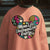 Pink sweatshirt with colorful design and text 'Mom Life: Unstoppable Energy' worn by a person.
