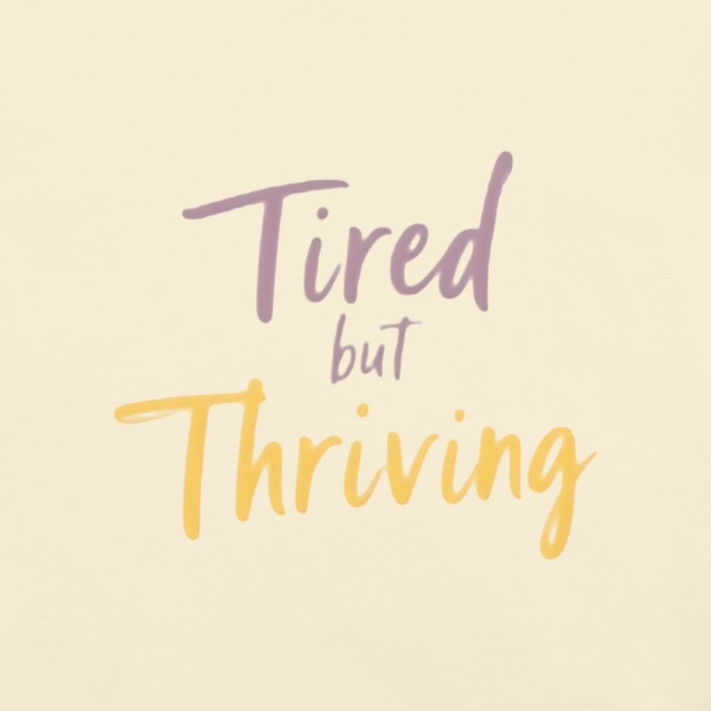 Garment-dyed relaxed fit t-shirt with motivational quote “Tired But Thriving” in modern handwritten script
