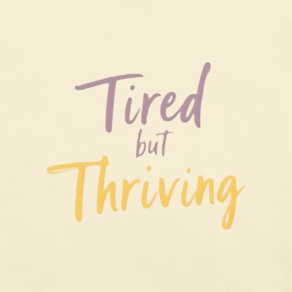 Garment-dyed relaxed fit t-shirt with motivational quote “Tired But Thriving” in modern handwritten script