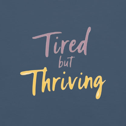 Garment-dyed relaxed fit t-shirt with motivational quote “Tired But Thriving” in modern handwritten script