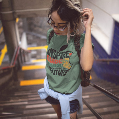 Woman wearing a green t-shirt with text at a train station