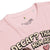 Pink t-shirt with text and graphic design on a white background