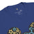 Close-up of a blue t-shirt with colorful graphics and a visible label on a white background