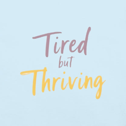 Garment-dyed relaxed fit t-shirt with motivational quote “Tired But Thriving” in modern handwritten script