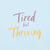 Garment-dyed relaxed fit t-shirt with motivational quote “Tired But Thriving” in modern handwritten script