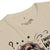 Beige t-shirt with graphic design and text on a white background