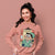 Woman wearing a pink sweatshirt with a cartoon character design on a pink background