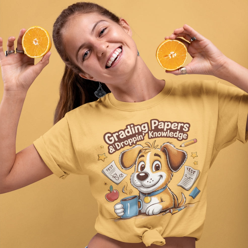 Person wearing a yellow t-shirt with a cartoon dog design and text, holding oranges against a yellow background.