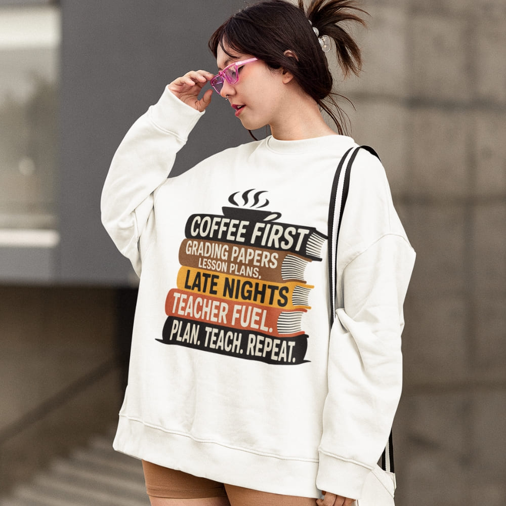 Person wearing a white sweatshirt with a humorous teacher quote design.
