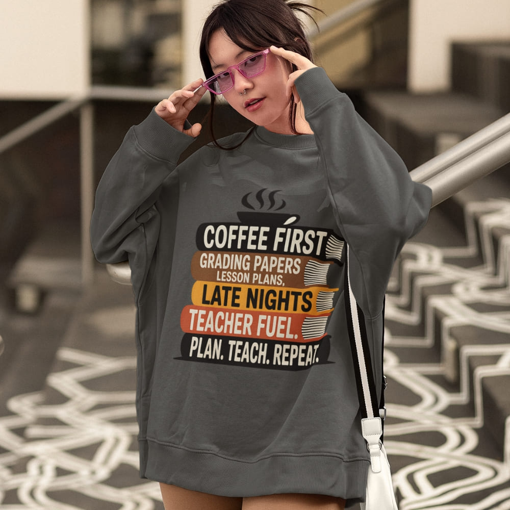 Person wearing a dark gray sweatshirt with text design outdoors.