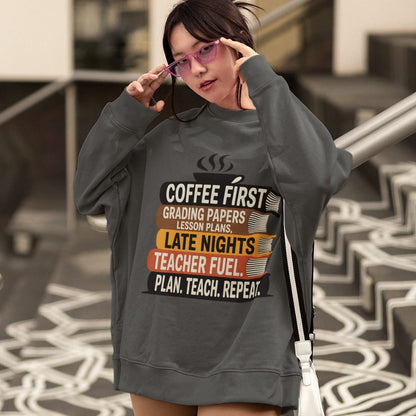 Person wearing a dark gray sweatshirt with text design outdoors.