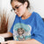 Person wearing a blue t-shirt with a graphic design and text