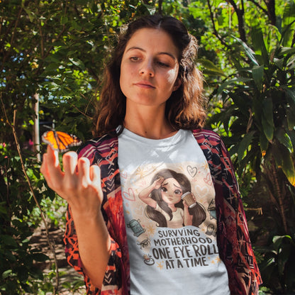 Woman wearing a t-shirt with a graphic design and text, standing outdoors with plants in the background
