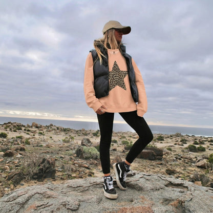 Person standing on a rocky outcrop with a scenic background