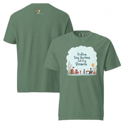 Illustrated t-shirt design with the quote "Building Tiny Humans with Big Dreams" surrounded by a family parenting scene