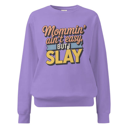 “Mommin' Ain’t Easy But I Slay” retro-style DTG printed design in peach, blue, and yellow on vintage garment-dyed fleece sweatshirt
