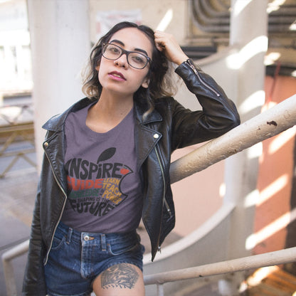Woman wearing a graphic t-shirt and leather jacket in an urban setting