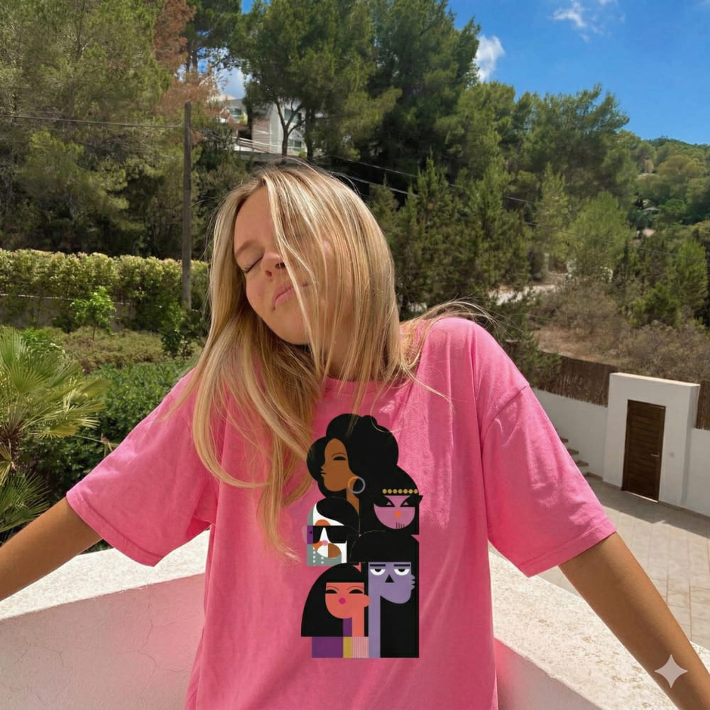 Person wearing a pink t-shirt with graphic designs outdoors